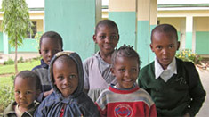 A group of primary students in Arusha, Tanzania, eagerly await their new BFA books.