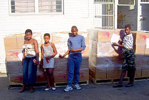 Children helping to unload books in South Africa.