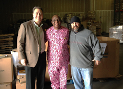Norm Linnell, BFA Board President (left), Inno Anoliefo (center), and a BFA warehouse staff member