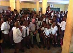 Tom Warth, founder of Books For Africa, poses with children that were delighted to receive books from the Sir Emeka Offor Foundation in Nigeria.