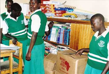 Students at a secondary school in Uganda unpack their new BFA books provided by Bega kwa Bega.