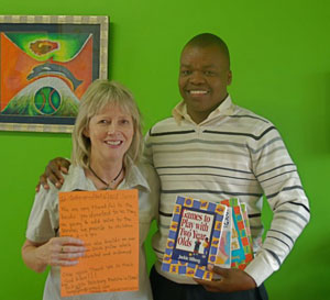 Pam Shelton, director and founder of the Botswana Book Project, and the director of the Bakgatla Bolokang Matshelo daycare in Botswana with some BFA books from the shipment.