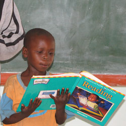 African student reading a textbook provided by BFA.