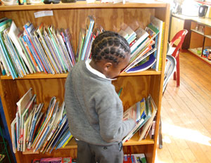 A Cape Town student picking out a BFA book at the school library.