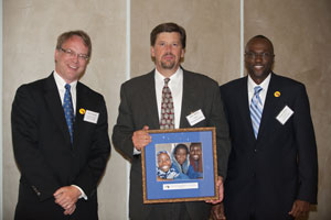 BFA Executive Director Pat Plonski, Dan Melin of Follett Educational Services, and BFA Board President Tom Gitaa presenting Follett Educational Services with the 2010 BFA Award of Merit for providing millions of books for shipment to children in Africa.