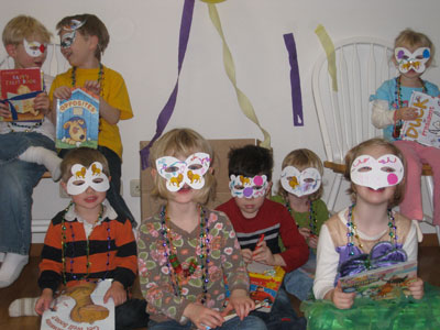 Siena Jacobson (third from right in the green shirt) celebrated her 3rd birthday in Germany with a Mardi Gras-themed party for Books For Africa.