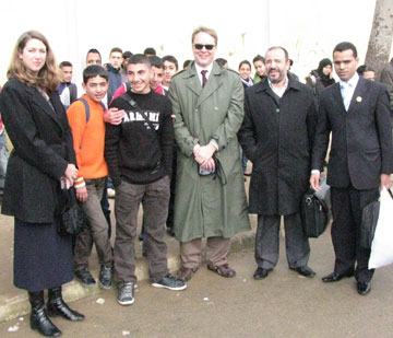 Gena Rhoades representing the U.S. Embassy, Parickt Plonski with Books For Africa, Mr. Jaanine Abdessalam of the Ministry of Education, Mustafa Walaf from Al Mansour Dhahbi Secondary School, and students outside a school in Ksar el Kebir, Morocco.