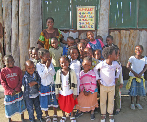 First graders and their teacher at Ray of Light School in Mozambique.