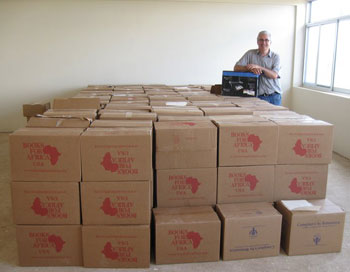 Father Martin Connell with 182 boxes of books for St. Peter Claver High School in Ihumwa, Tanzania.