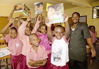 Students at Kibangu School in Tanzania celebrate receiving their Books For Africa books.