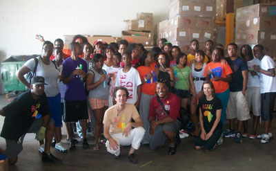 Bound Program Director Christopher Goins (kneeling in red) poses with his enthusiastic group after a hard morning's work at Books For Africa's Atlanta Warehouse.