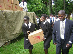 Students at Chifunabuli Basic School moving books off a truck to the new library.